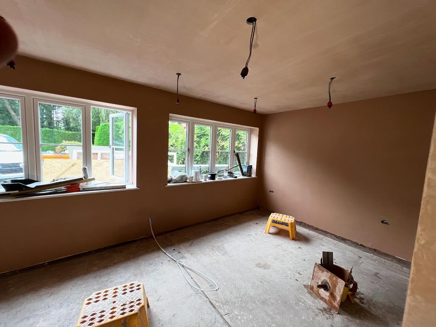 A room with a run of windows, walls and ceiling skimmed