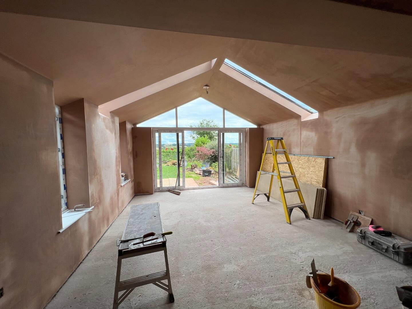 A long vaulted room with gable glazing, freshly plastered