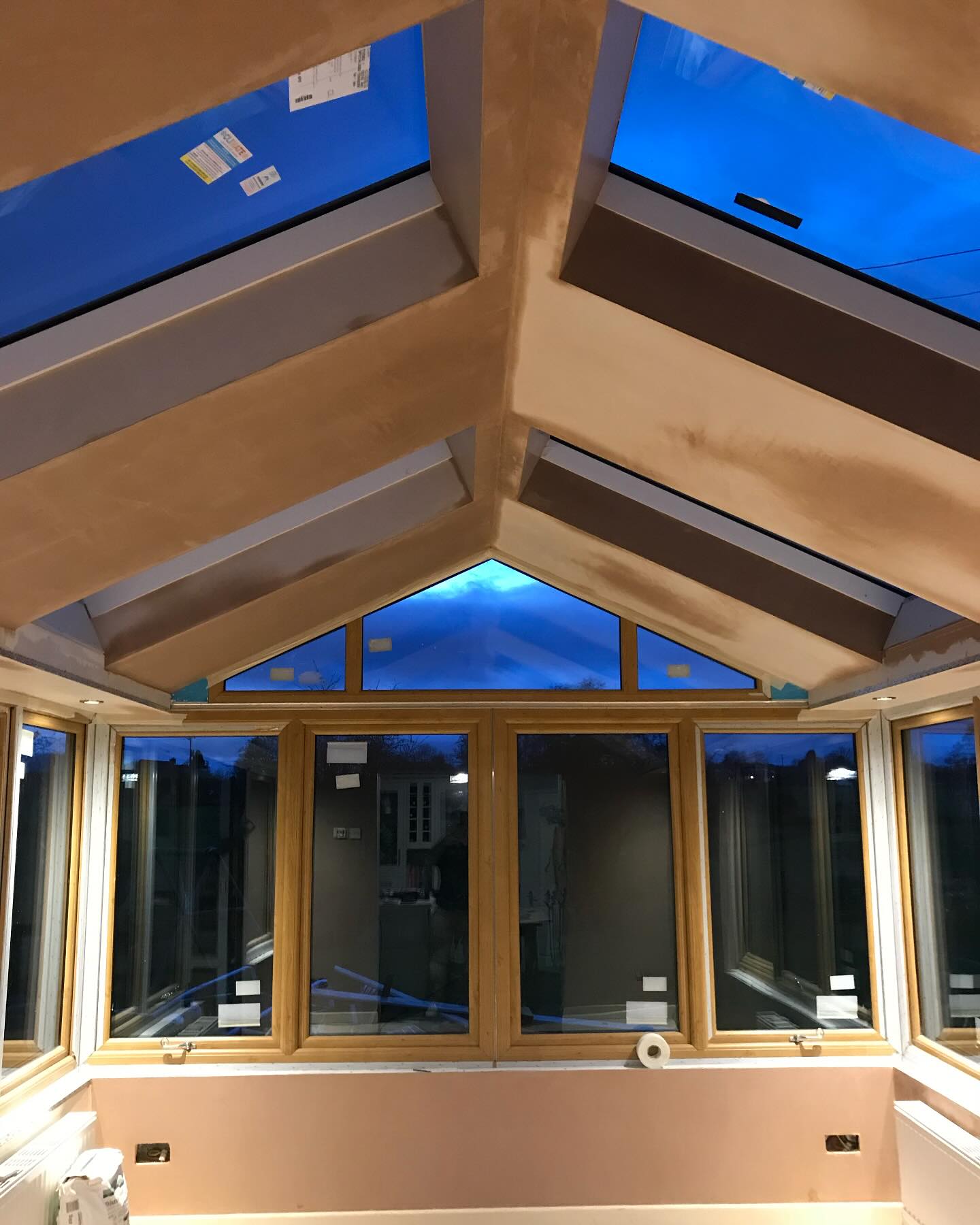 An orangery with a roof lantern, walls and ceiling freshly plastered