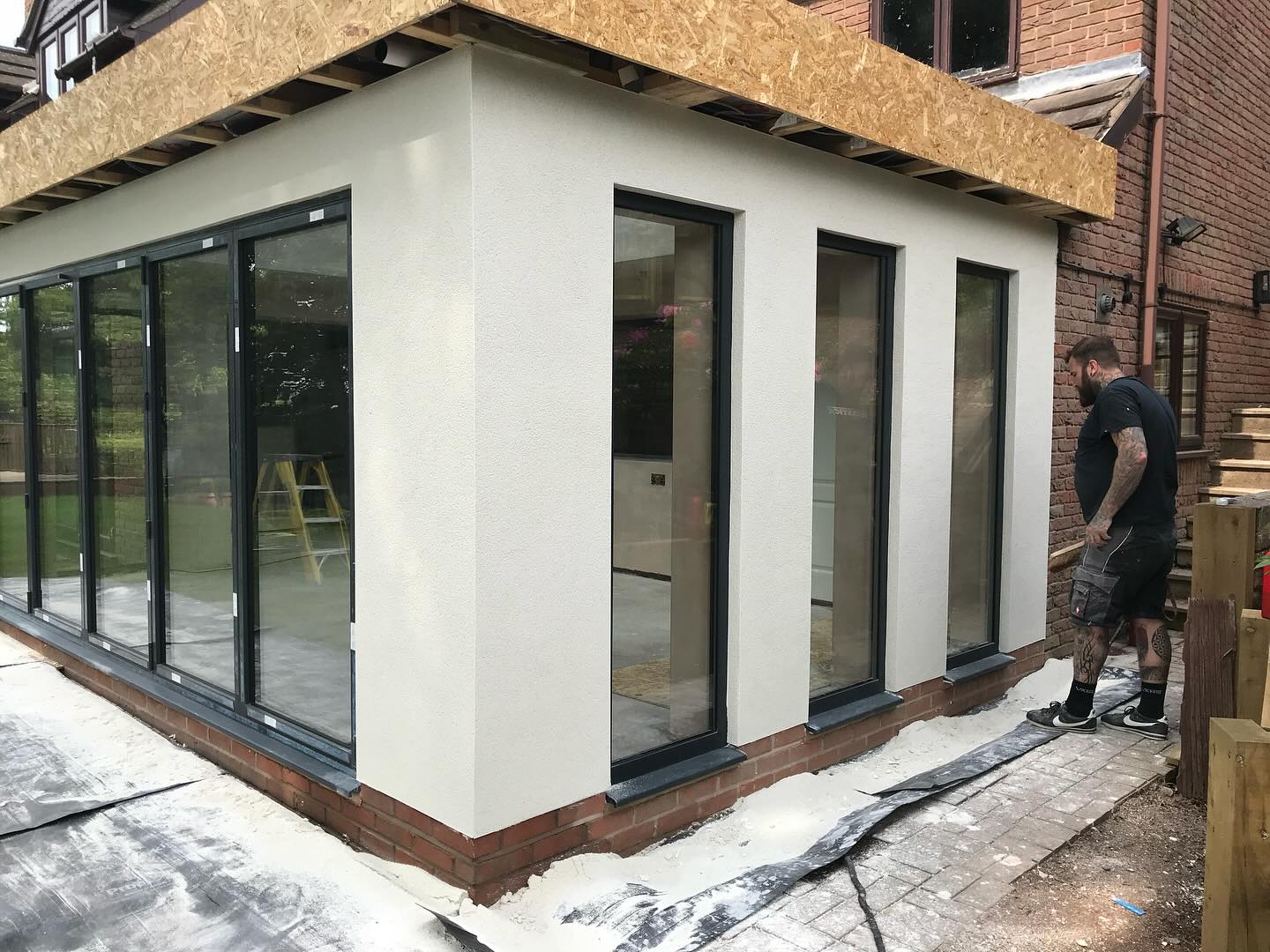 A new extension rendered white, with one of the team on site