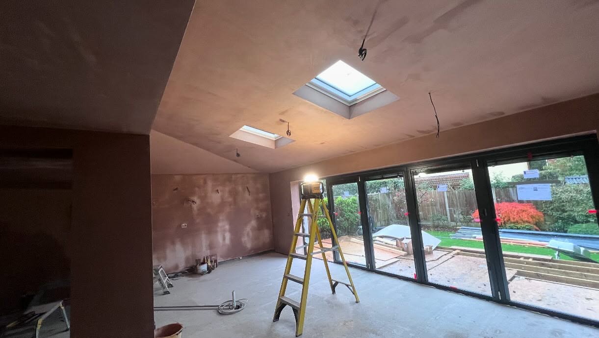 An extension with roof lights and bi-fold doors after plastering