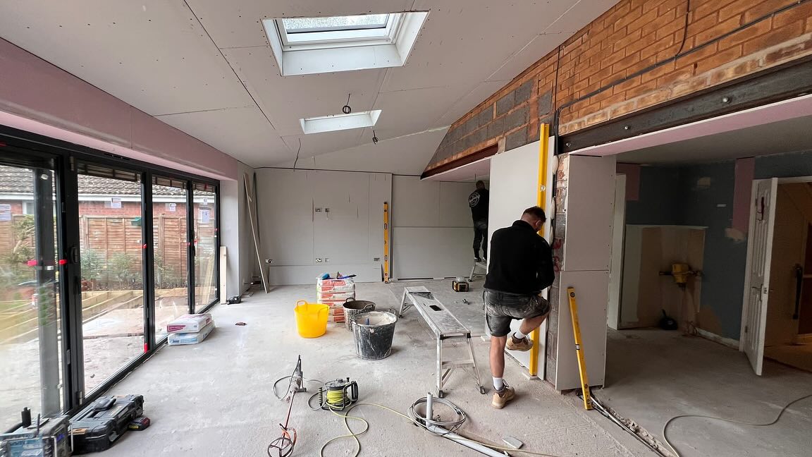 The team at work in an extension with roof lights and bi-fold doors