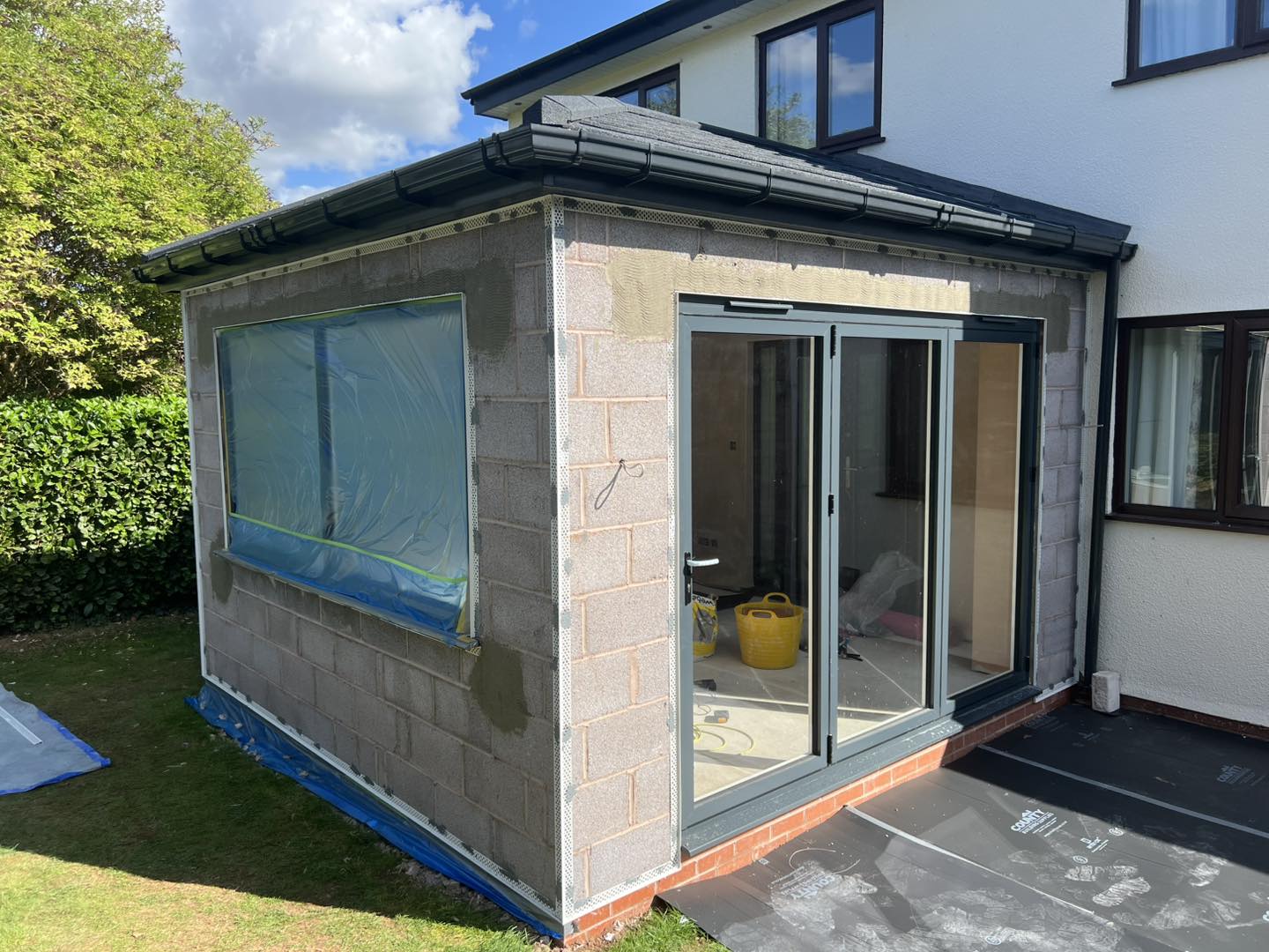 A block-built extension with its windows covered, before rendering